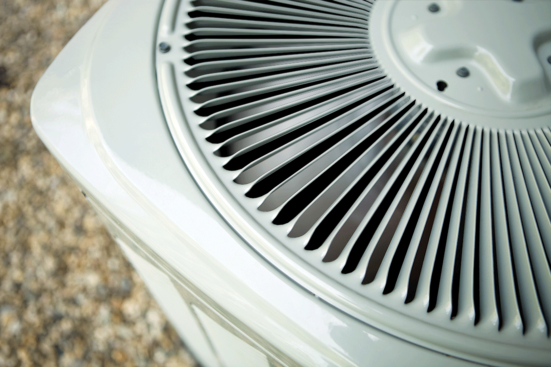 close up shot of the top of an air conditioner coil with the fan blades spinning