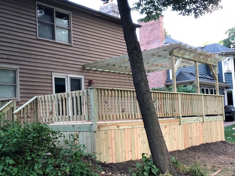 brown colored house with new unfinished deck