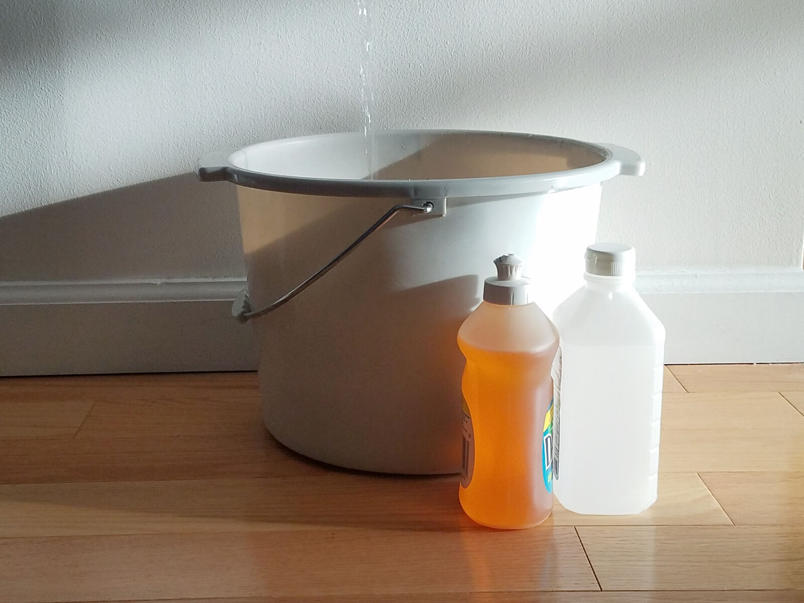 bucket of hot water with dish soap and rubbing alcohol